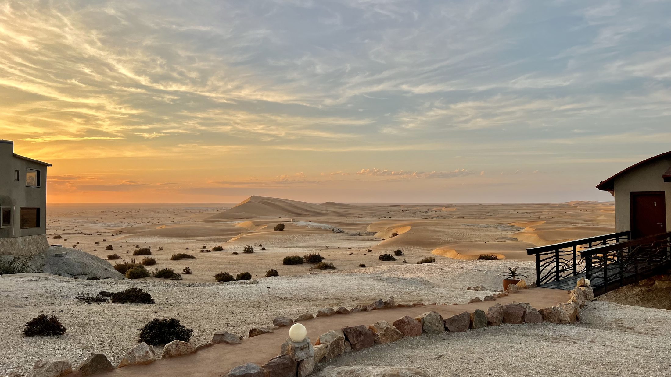 Desert Breeze bungalows and dunes in warm sunset light