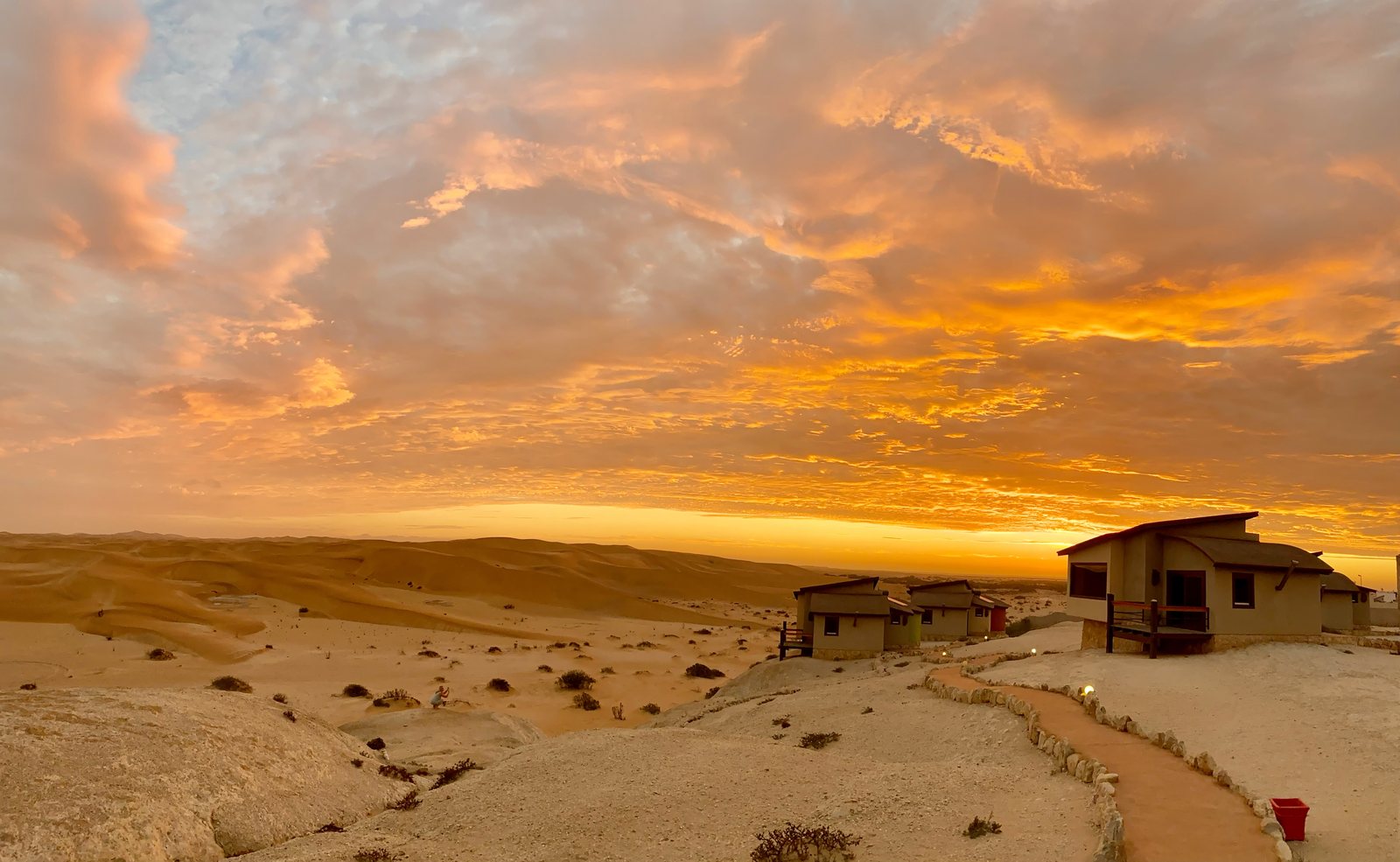 Desert Breeze bungalow beneath a dramatic sunset sky